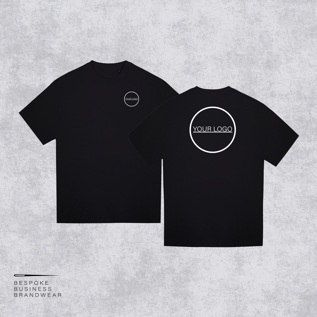 Two black short-sleeve t-shirts shown on a light gray textured background, with the front view on the left and back view on the right. Both shirts feature a white circular logo placeholder; the back shirt has a larger circular logo with the text 'YOUR LOGO'.