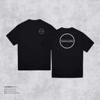 Two black short-sleeve t-shirts shown on a light gray textured background, with the front view on the left and back view on the right. Both shirts feature a white circular logo placeholder; the back shirt has a larger circular logo with the text 'YOUR LOGO'.